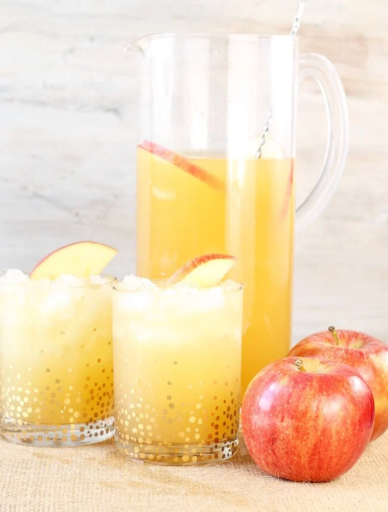pitcher of fall party punch with two glasses of punch