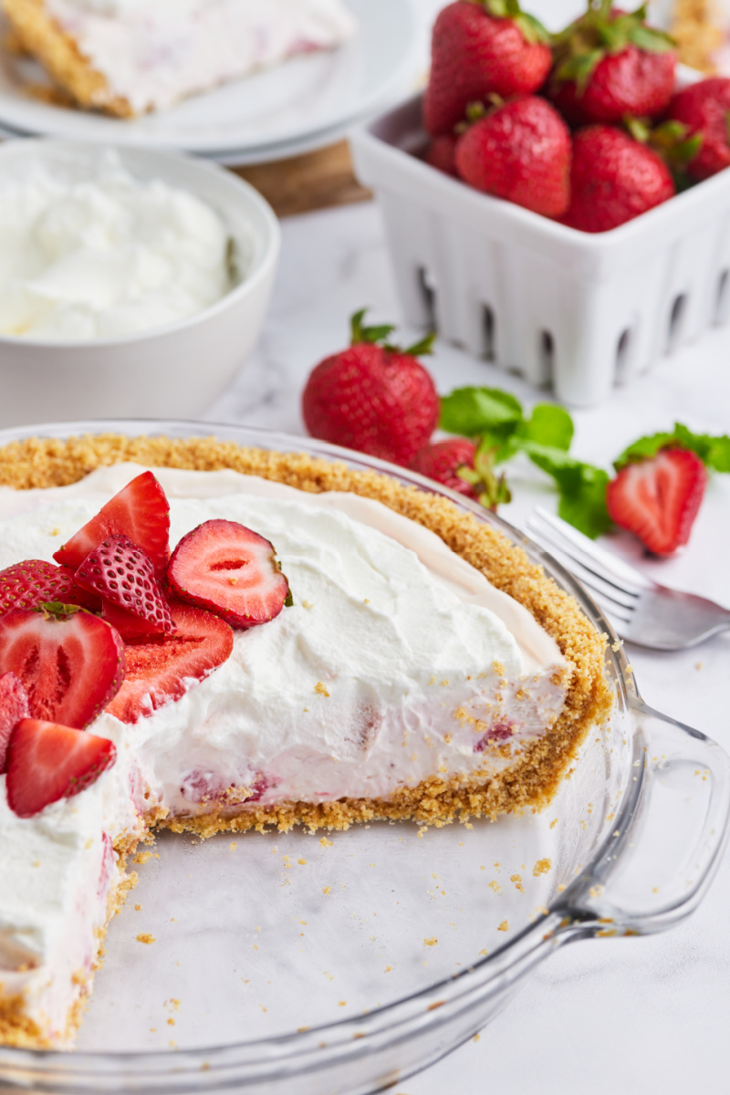 no bake strawberry cream pie with a big slice taken out of it