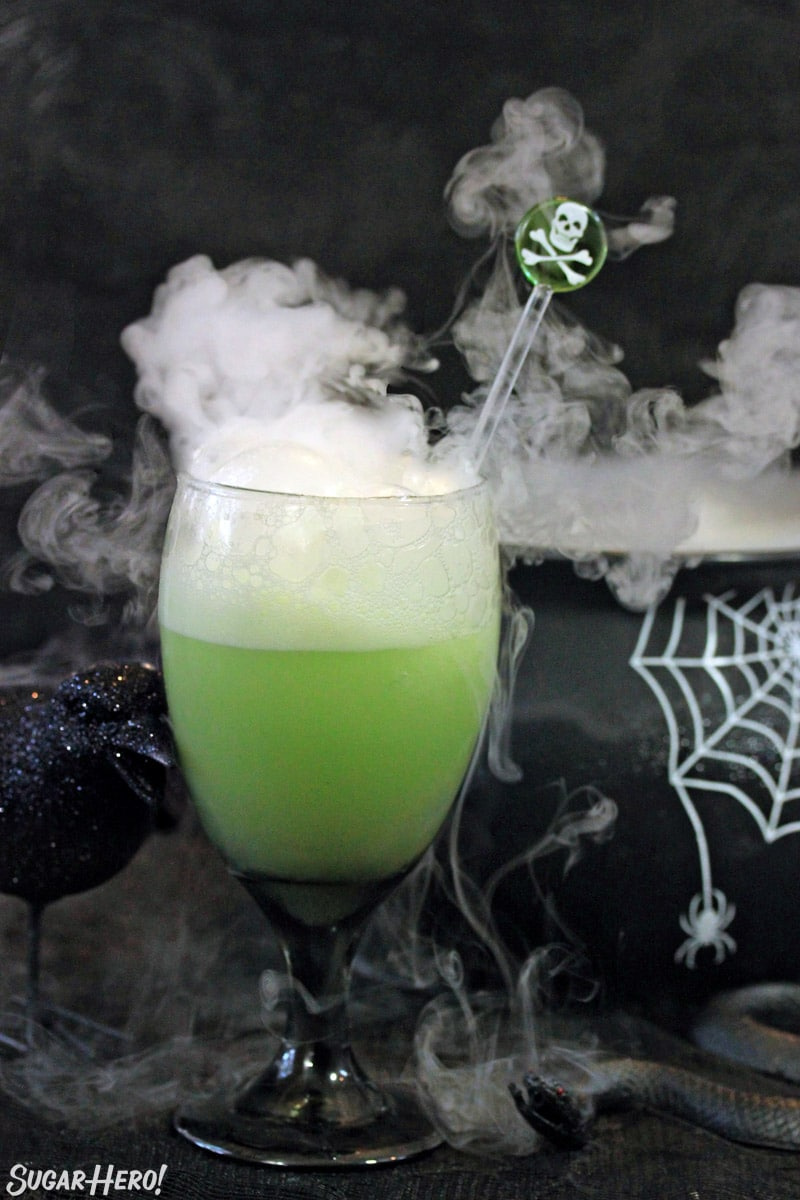 glass of witches brew halloween punch with dry ice