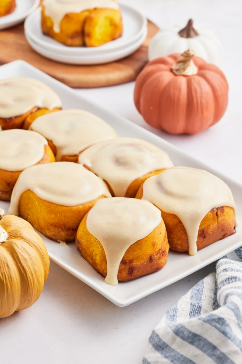 pumpkin cinnamon rolls on white platter