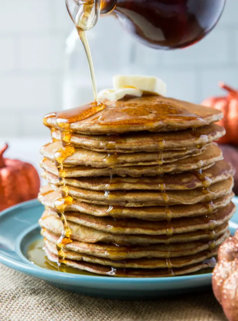 stack of pumpkin pancakes with syrup