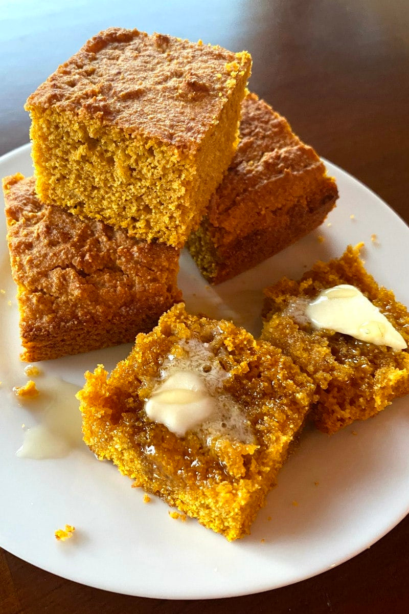 slices of pumpkin cornbread with butter and honey
