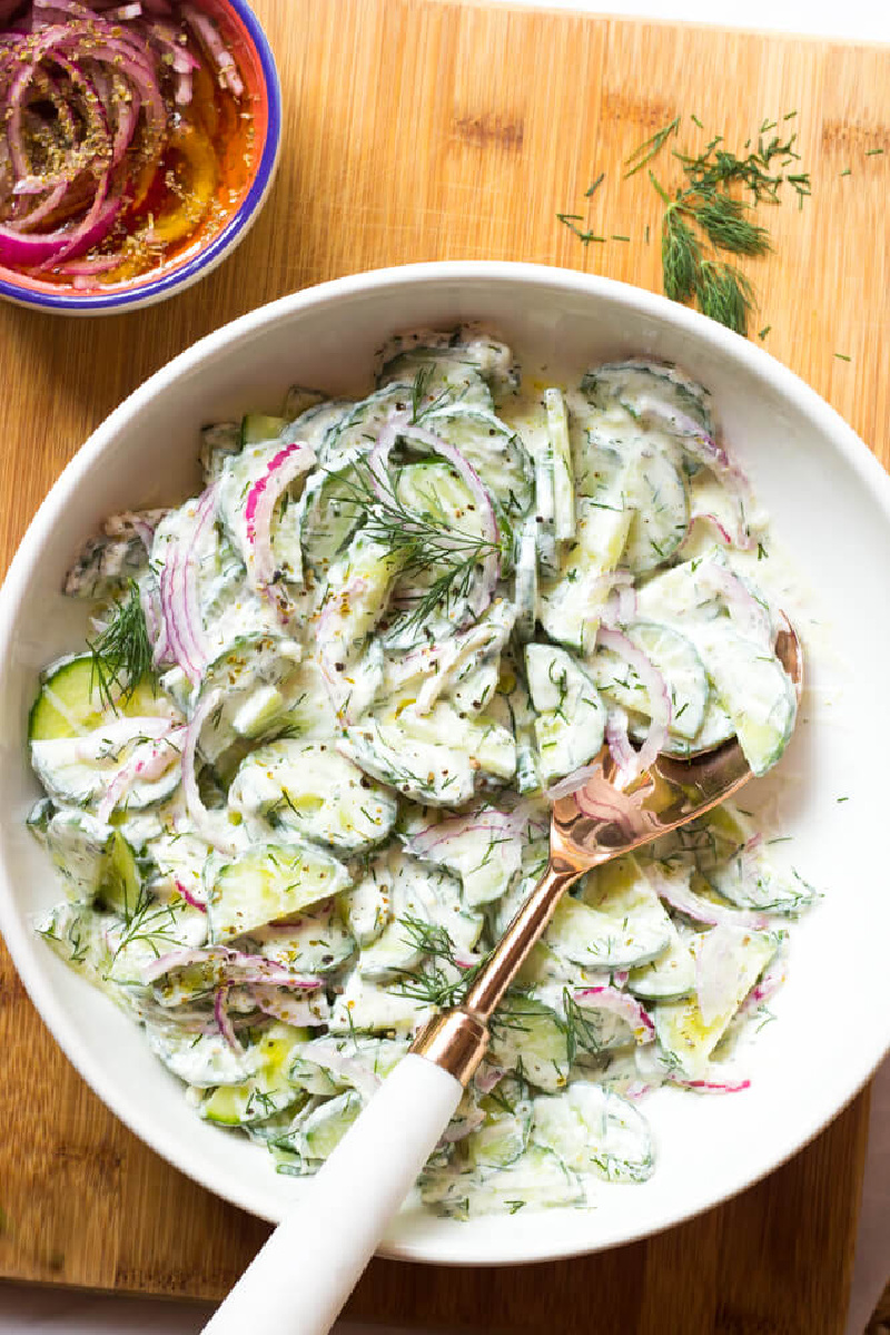 greek yogurt cucumber salad in a bowl with a fork