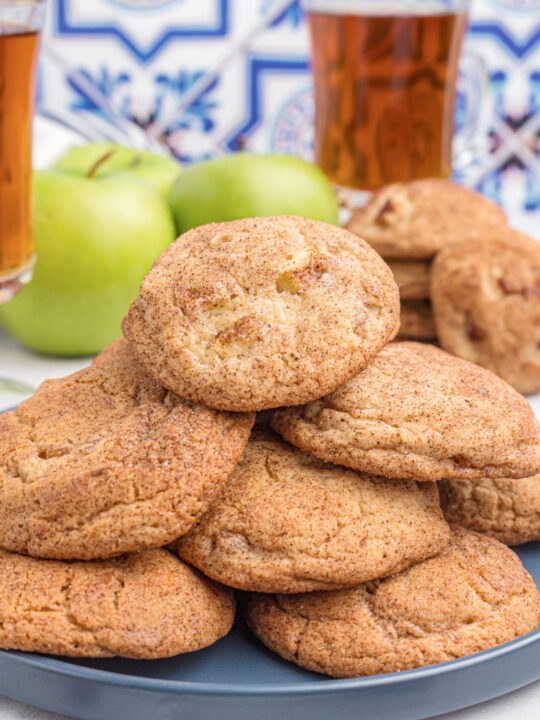apple cider snickerdoodles stacked on a platter