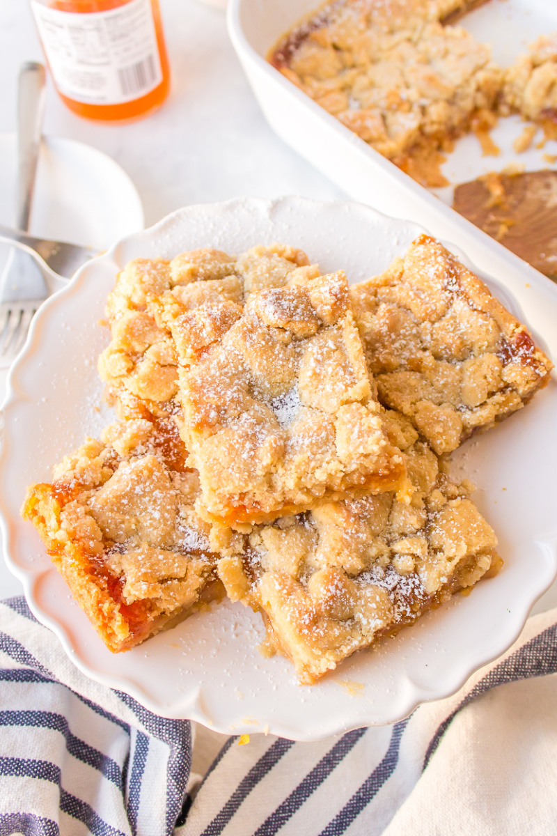 several apricot shortbread bars on a platter