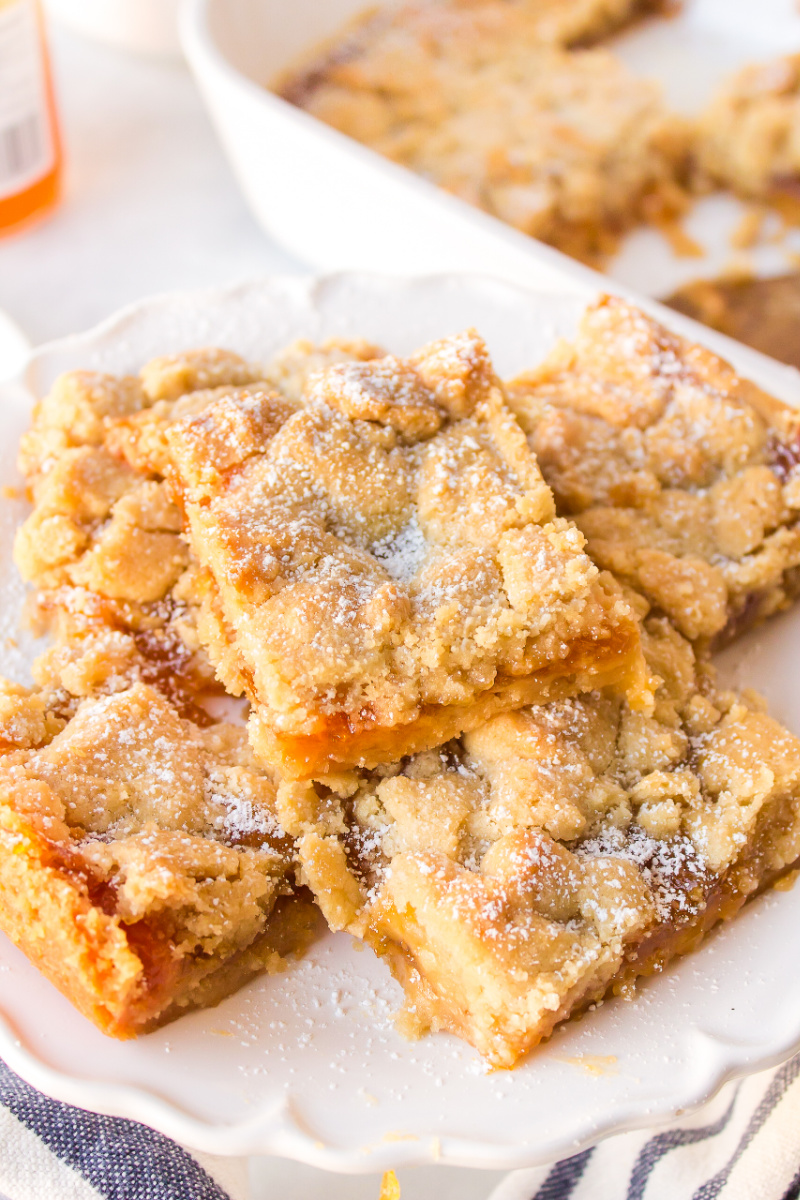 several apricot shortbread bars on a platter