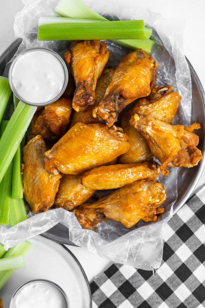 bowl of buffalo wings with celery and sauce