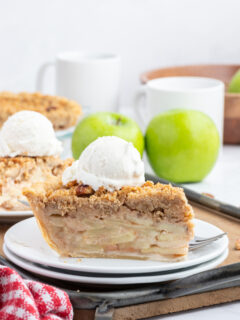 slice of dutch apple pie with scoop of vanilla ice cream on top