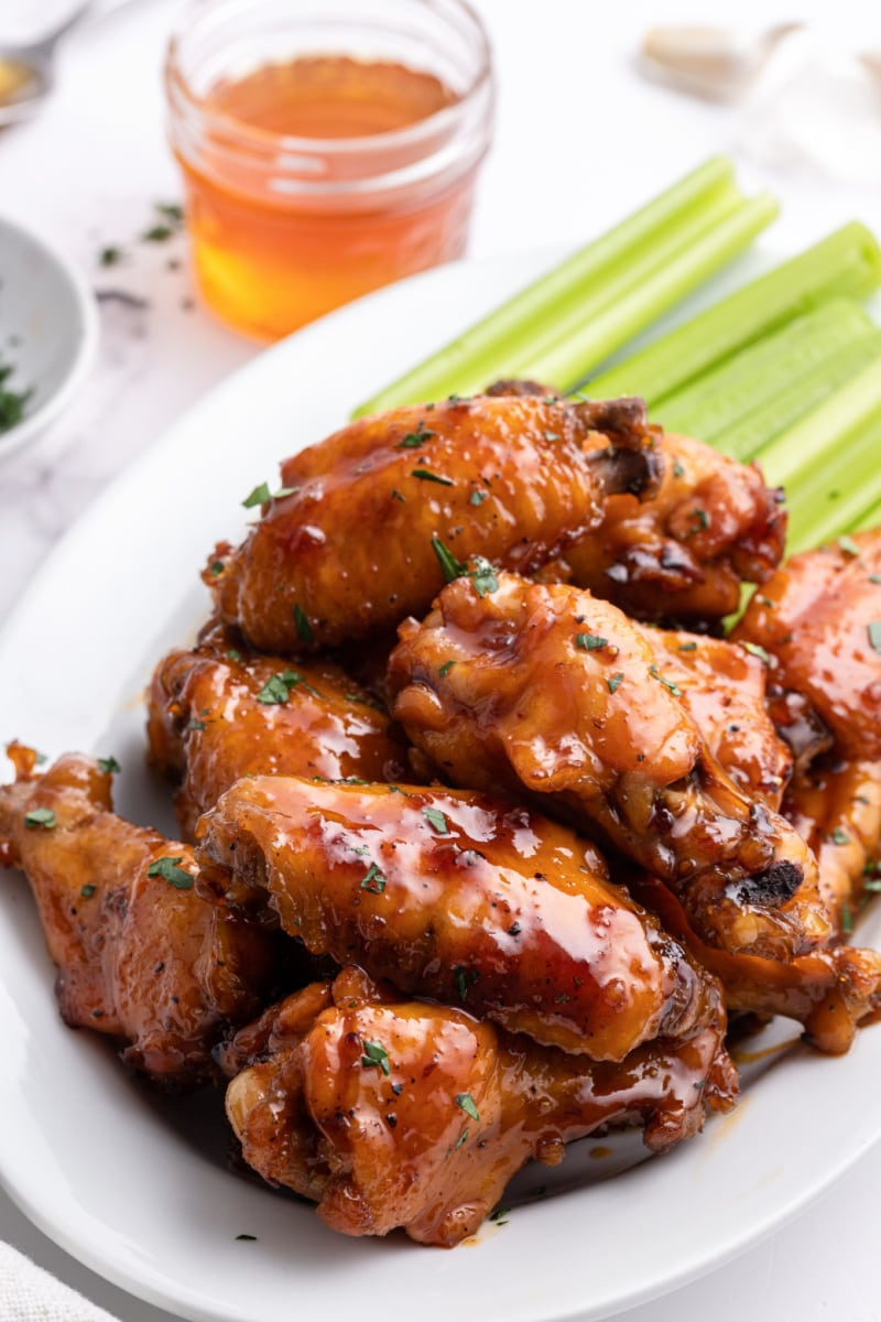 honey glazed chicken wings on plate with celery