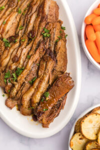 brisket sliced on a white platter