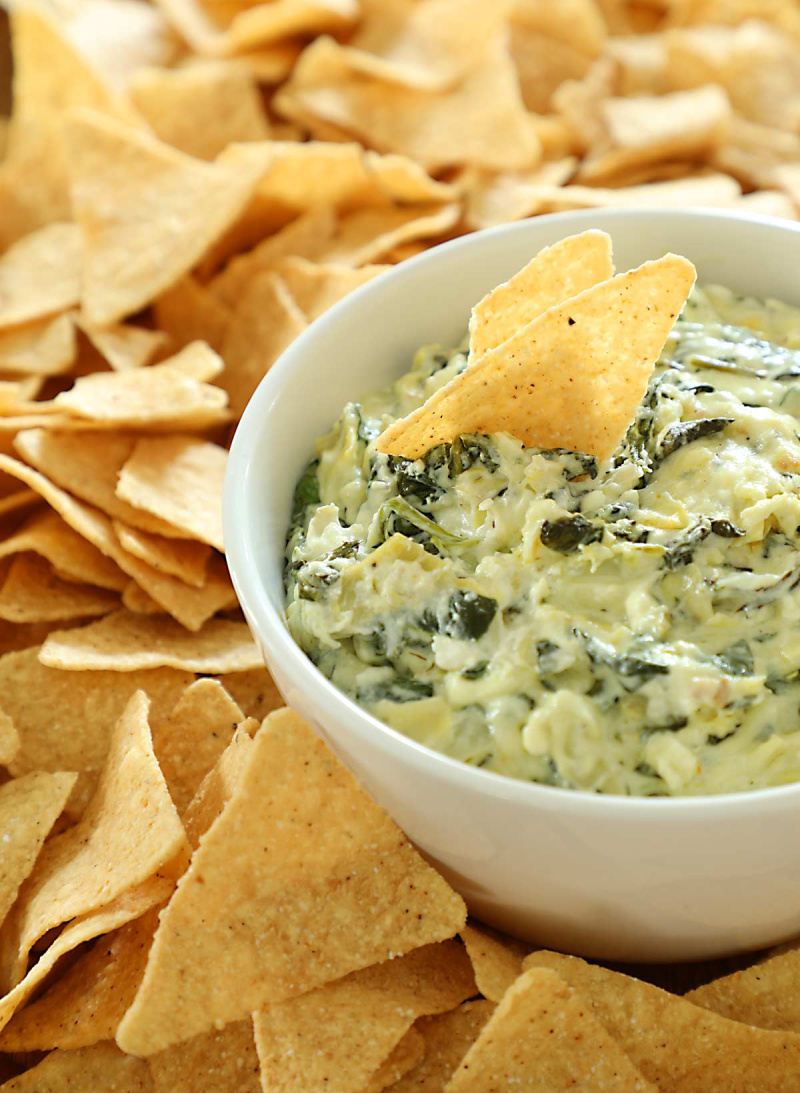 baked feta spinach artichoke dip in dish with chips