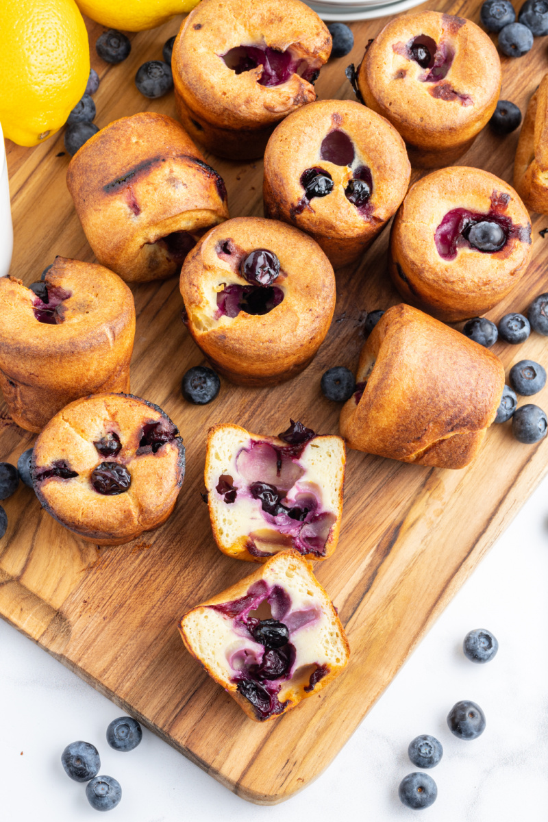 blueberry popovers on a board one cut in half