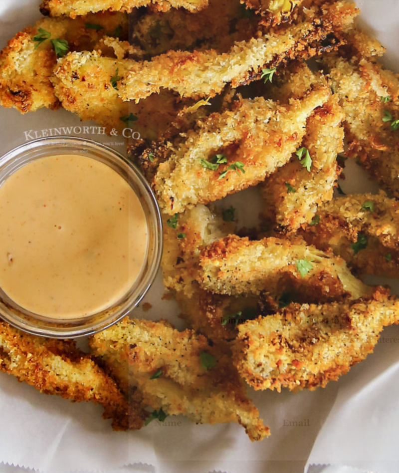 crispy air fried artichoke hearts with dish of sauce