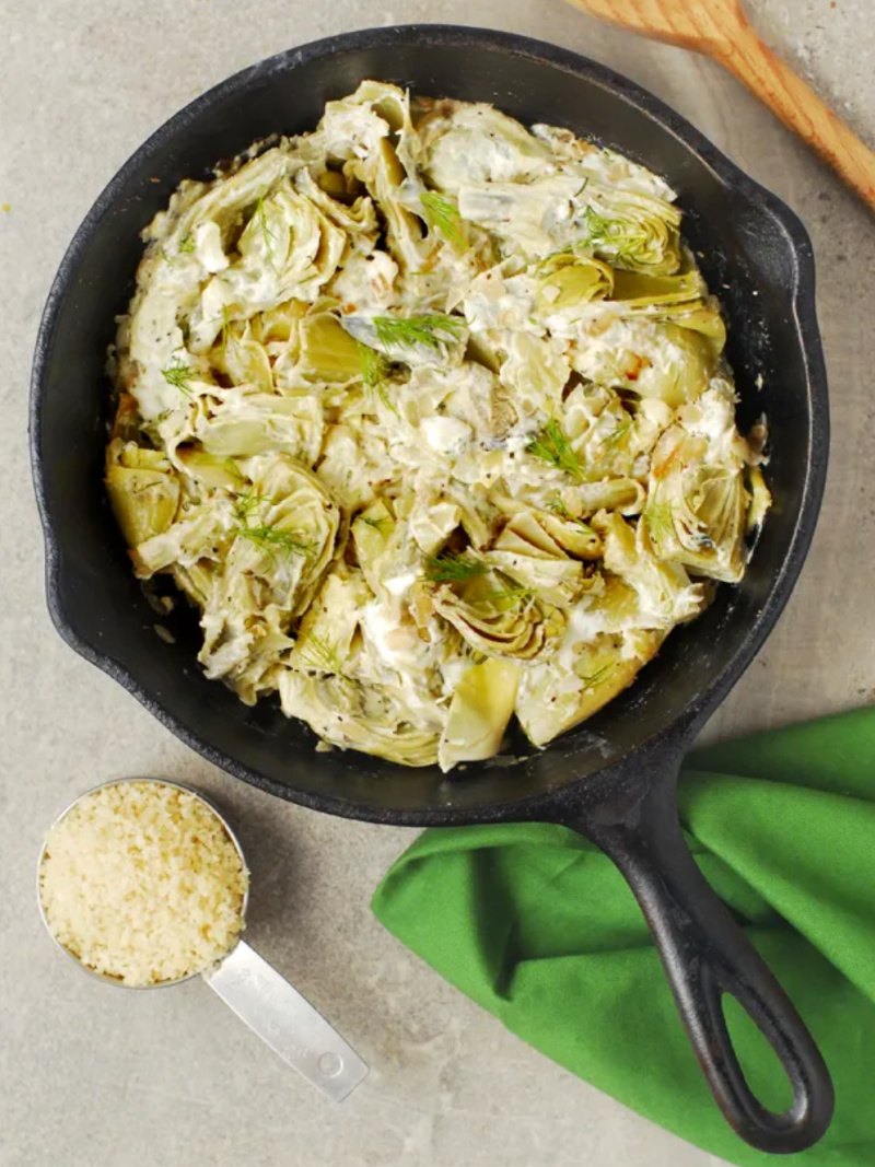 oat cheese baked artichoke hearts in cast iron skillet