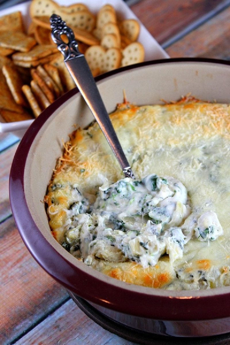 lighter spinach artichoke dip in dish with spoon