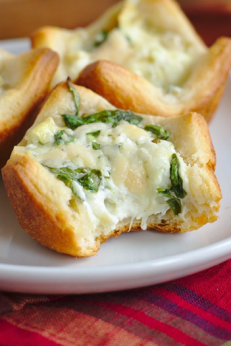 spinach artichoke bites on plate with bite taken out