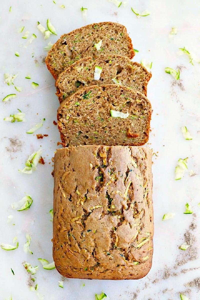 loaf of healthy olive oil zucchini bread with a few slices
