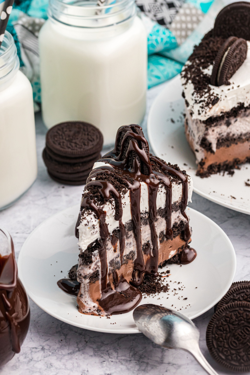 slice of ice cream cake with hot fudge drizzled over