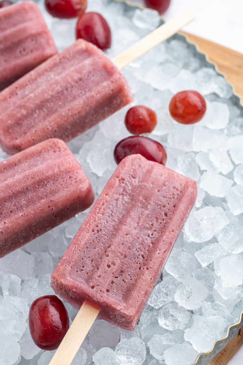grape popsicles sitting on ice
