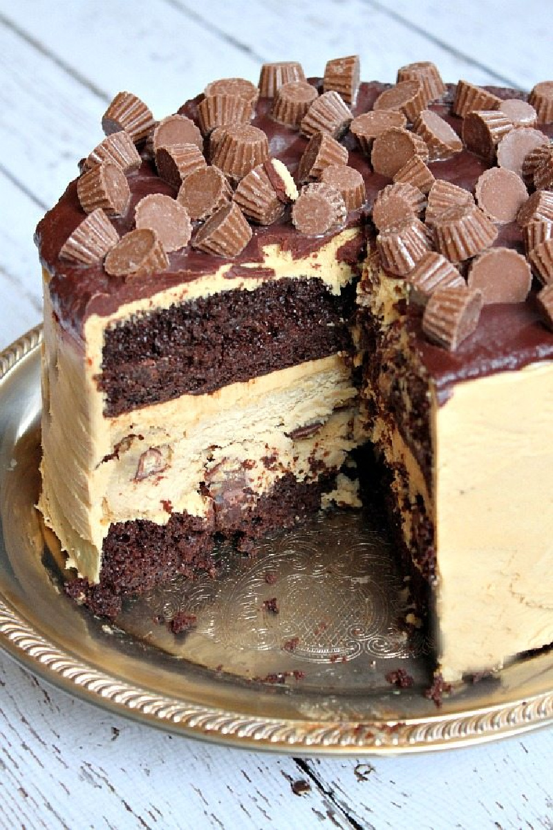 chocolate peanut butter cup cheesecake cake with slice taken out