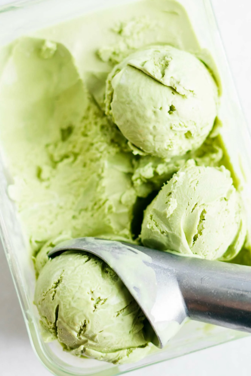 matcha ice cream in bin with scoops