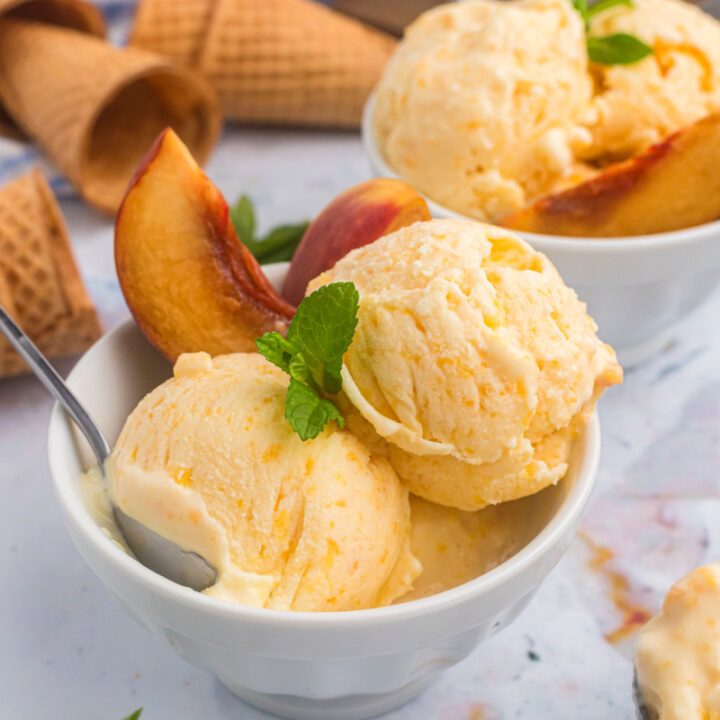 scoops of peach ice cream in bowl