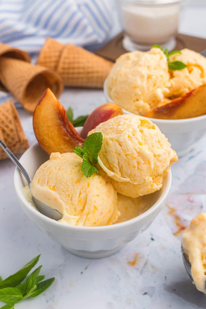 scoops of peach ice cream in bowl