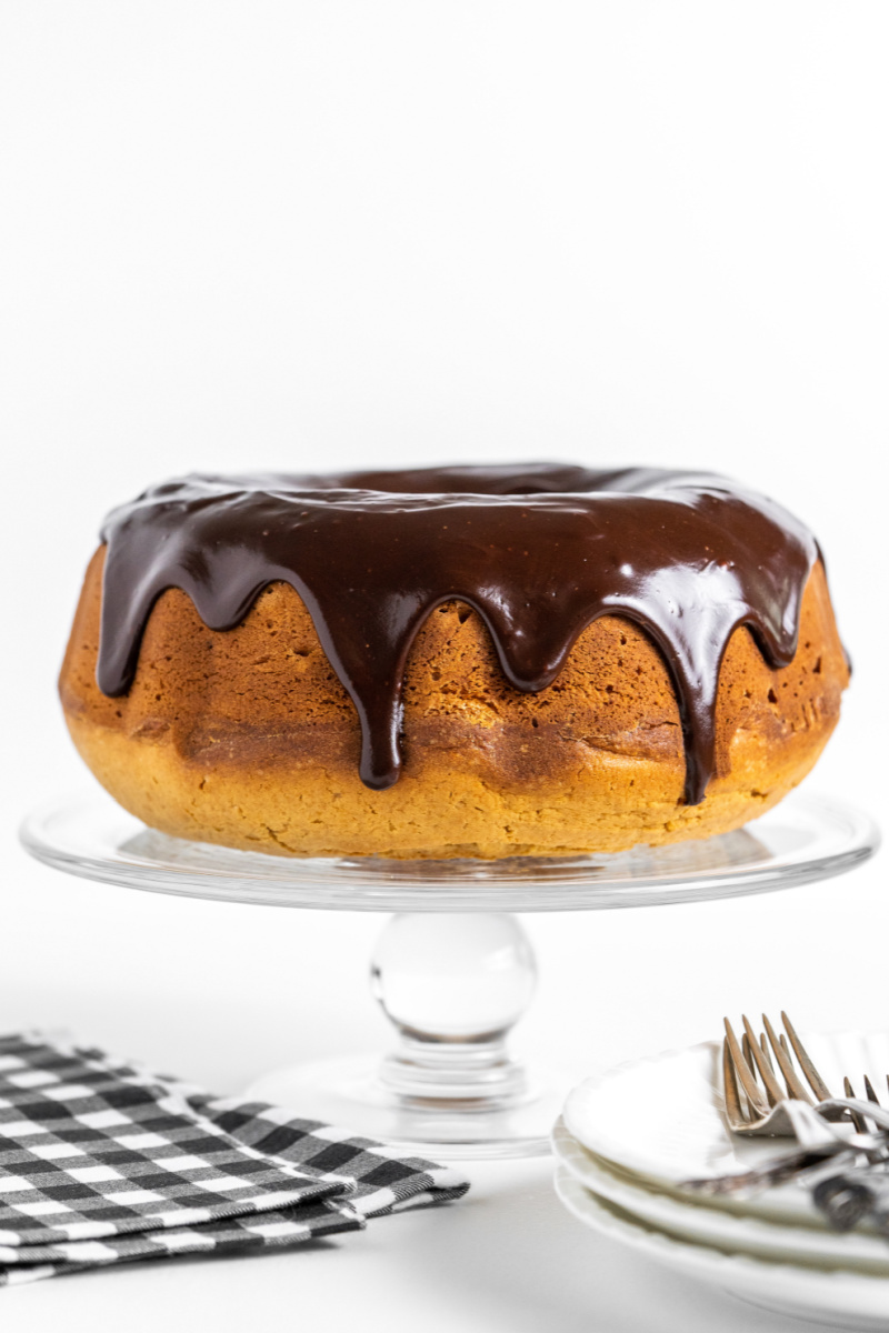 peanut butter bundt cake with chocolate glaze on a cake platter