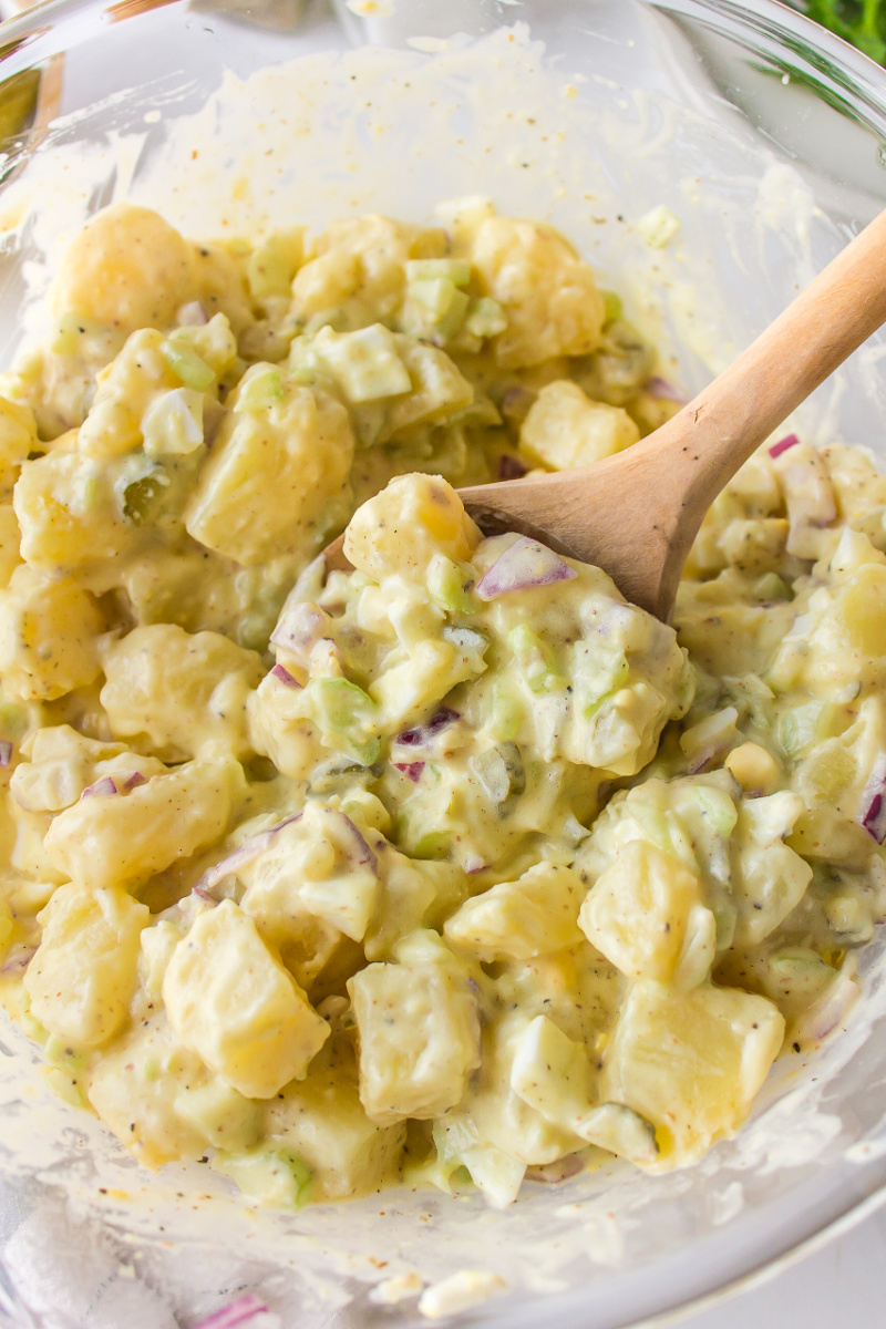 sweet pickle potato salad in a bowl with a spoon