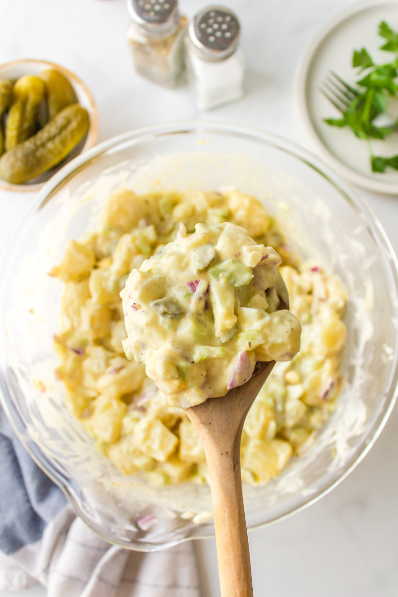 spoonful of sweet pickle potato salad over bowl of potato salad