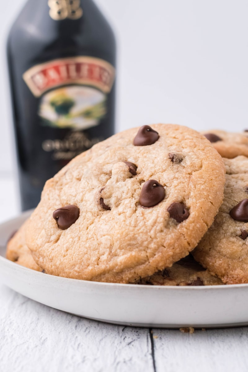 baileys chocolate chip cookies on a plate with bottle of baileys