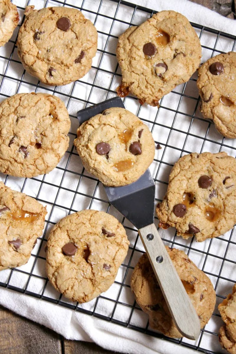 salted caramel chocolate chip cookies on a baking rack