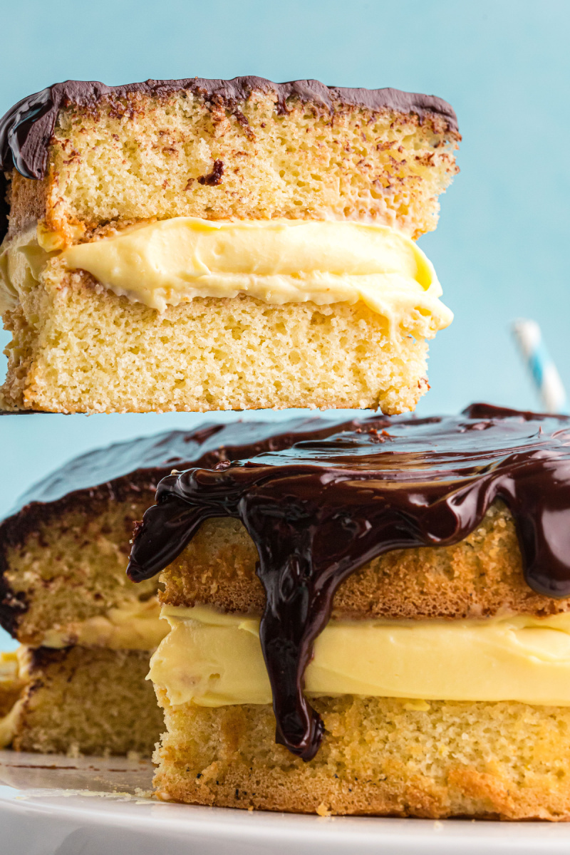 slice of boston cream pie being taken out of the cake