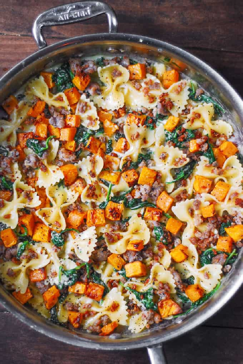 pan of butternut squash pasta with sausage and spinach
