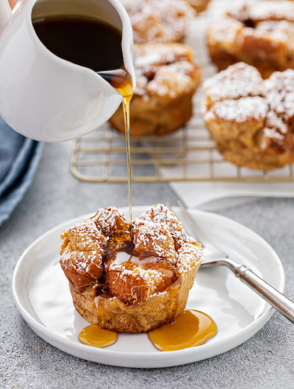 baked french toast muffin with syrup drizzled over