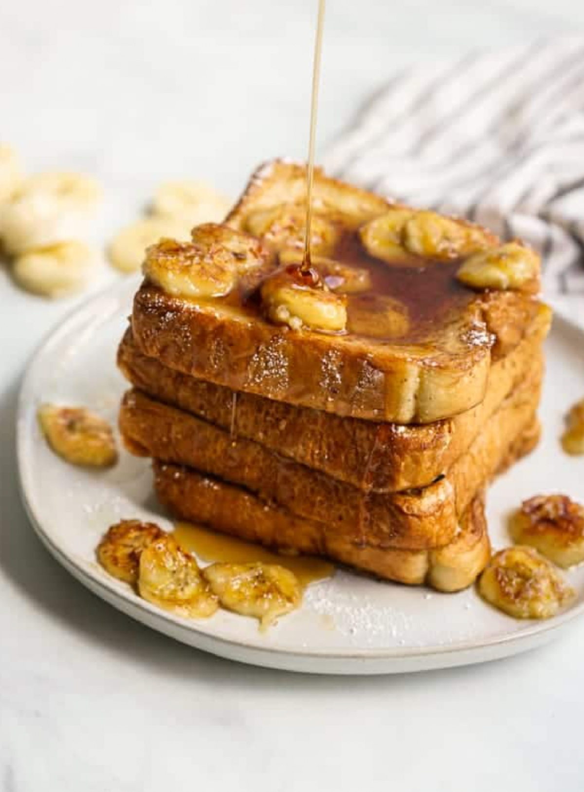 stacked caramelized banana french toast on plate