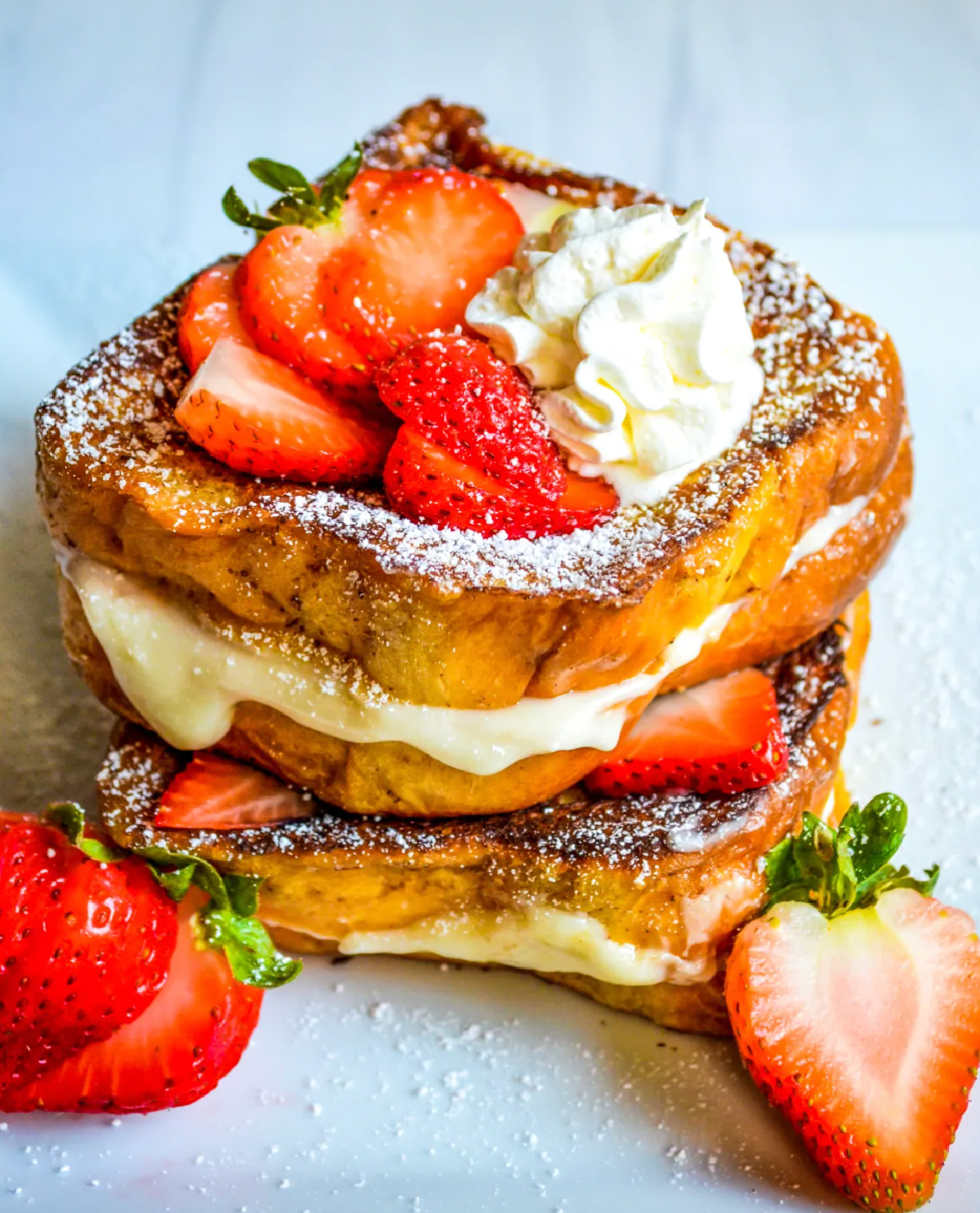 stacked cream cheese stuffed french toast wit strawberries