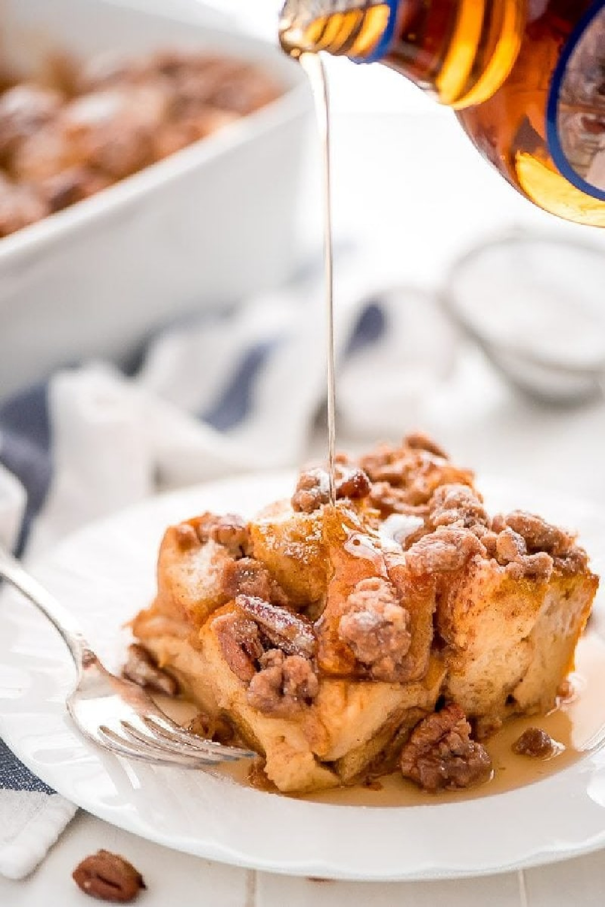 slice of pumpkin french toast casserole on plate with syrup