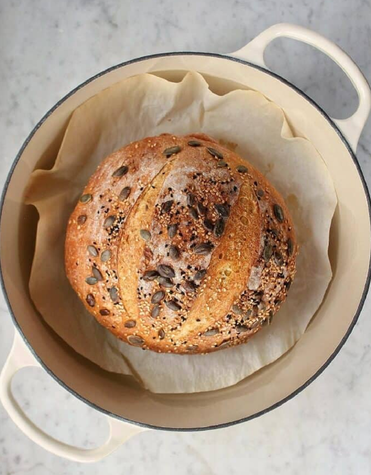 round loaf of pumpkin no knead bread in dutch oven