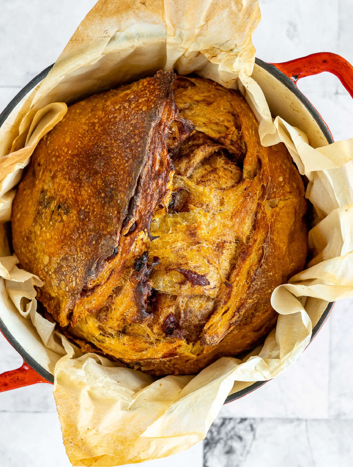 round loaf of pumpkin sourdough bread in dutch oven