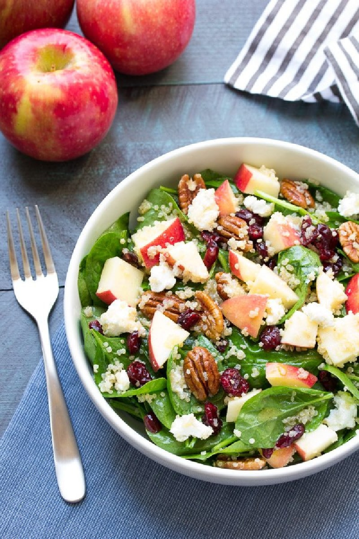 spinach and quinoa salad with apple in bowl