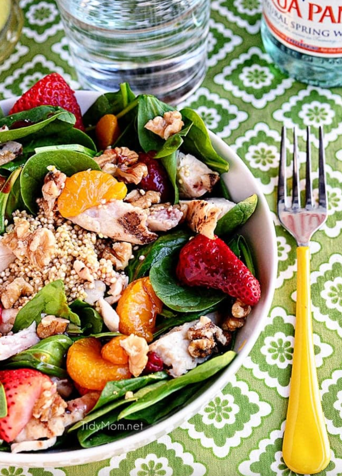 strawberry orange spinach salad with quinoa in bowl