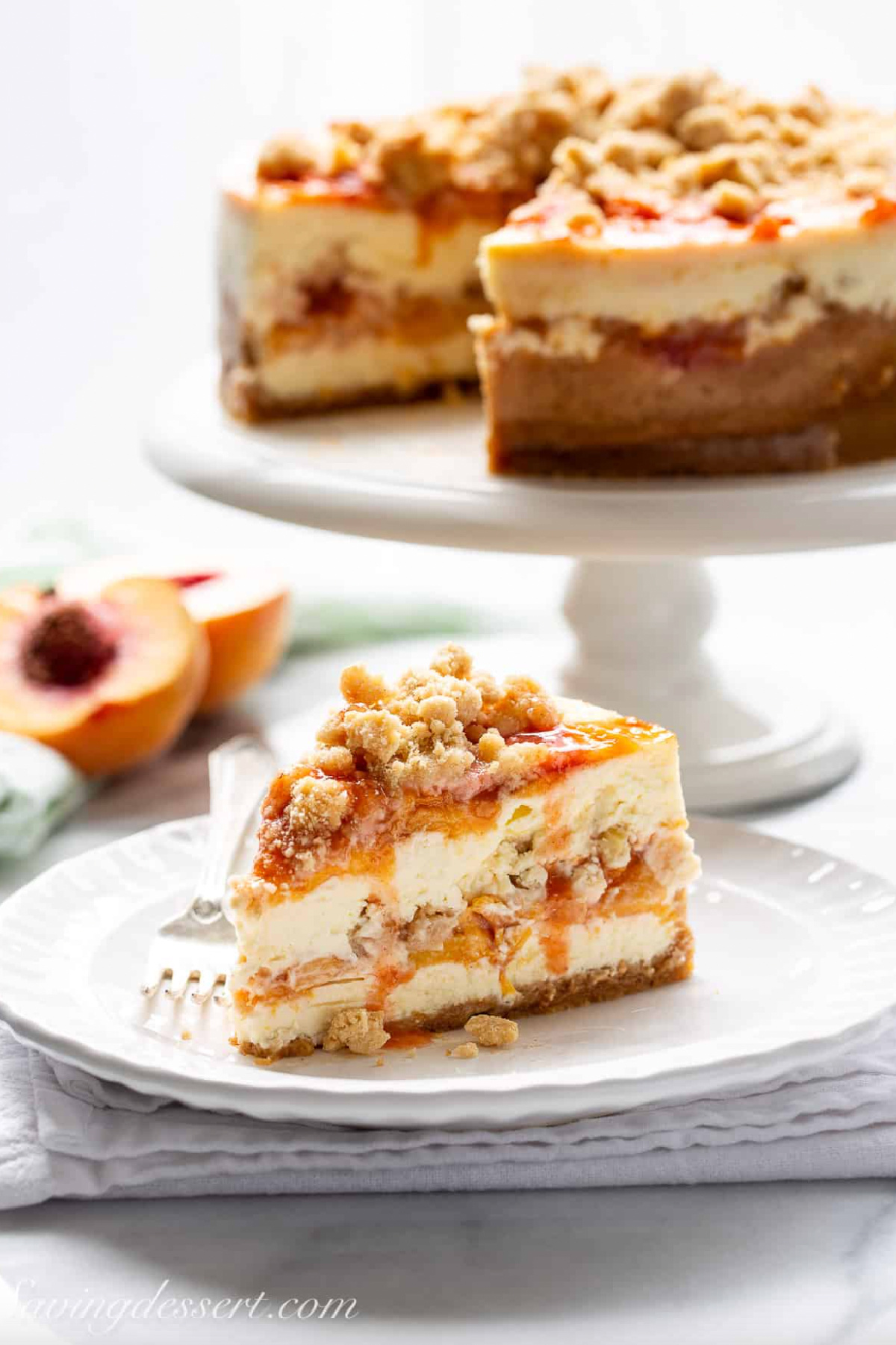 slice of peach cobbler cheesecake on plate