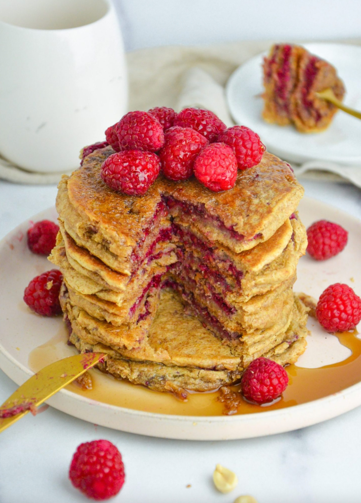 stack of peanut butter and jelly pancakes with big bite taken out of it