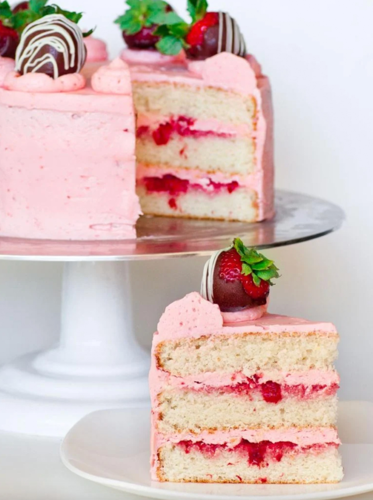 strawberry champagne cake slice with cake in background