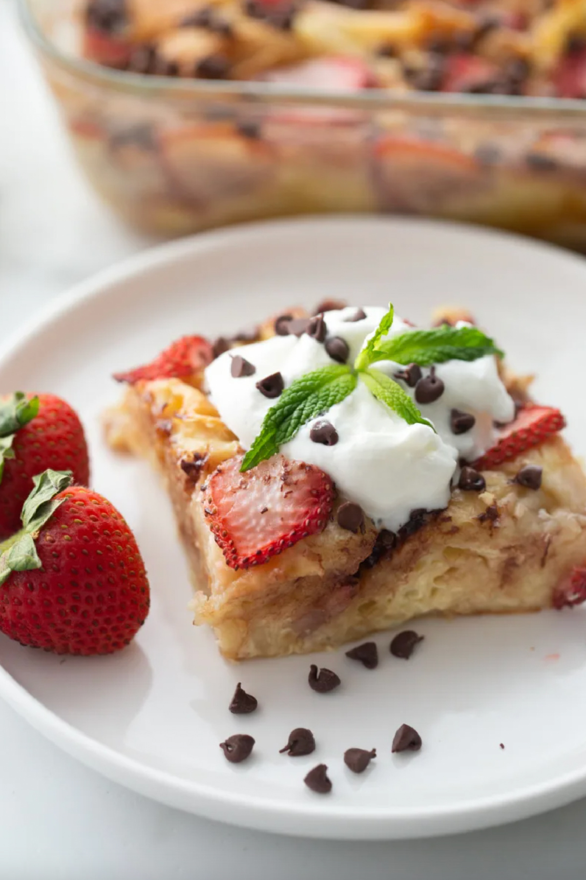 serving of strawberry chocolate chip croissant pudding on plate