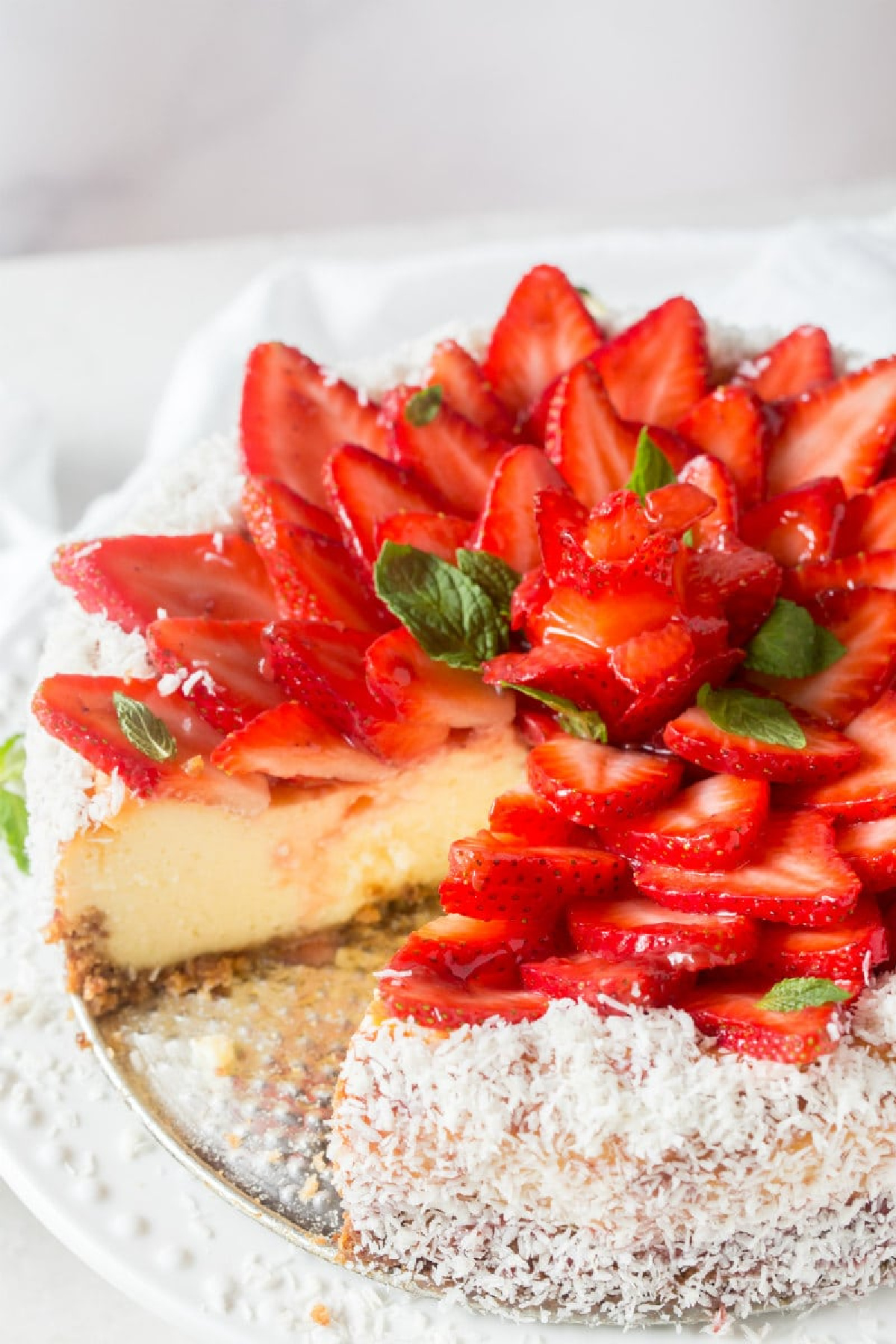 strawberry coconut cheesecake with slice taken out