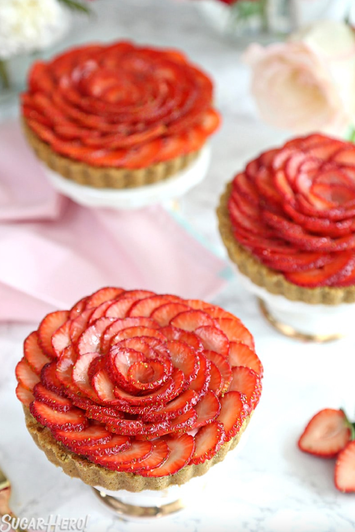 three strawberry rose tarts