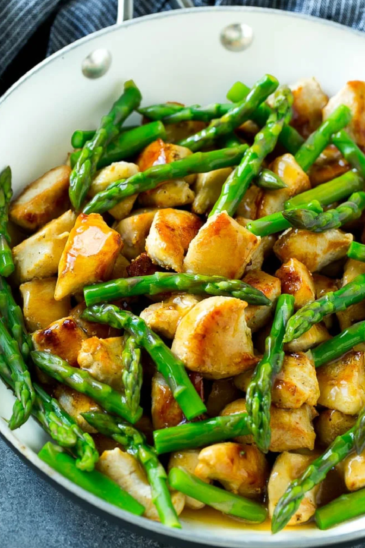 chicken and asparagus stir fry in pan