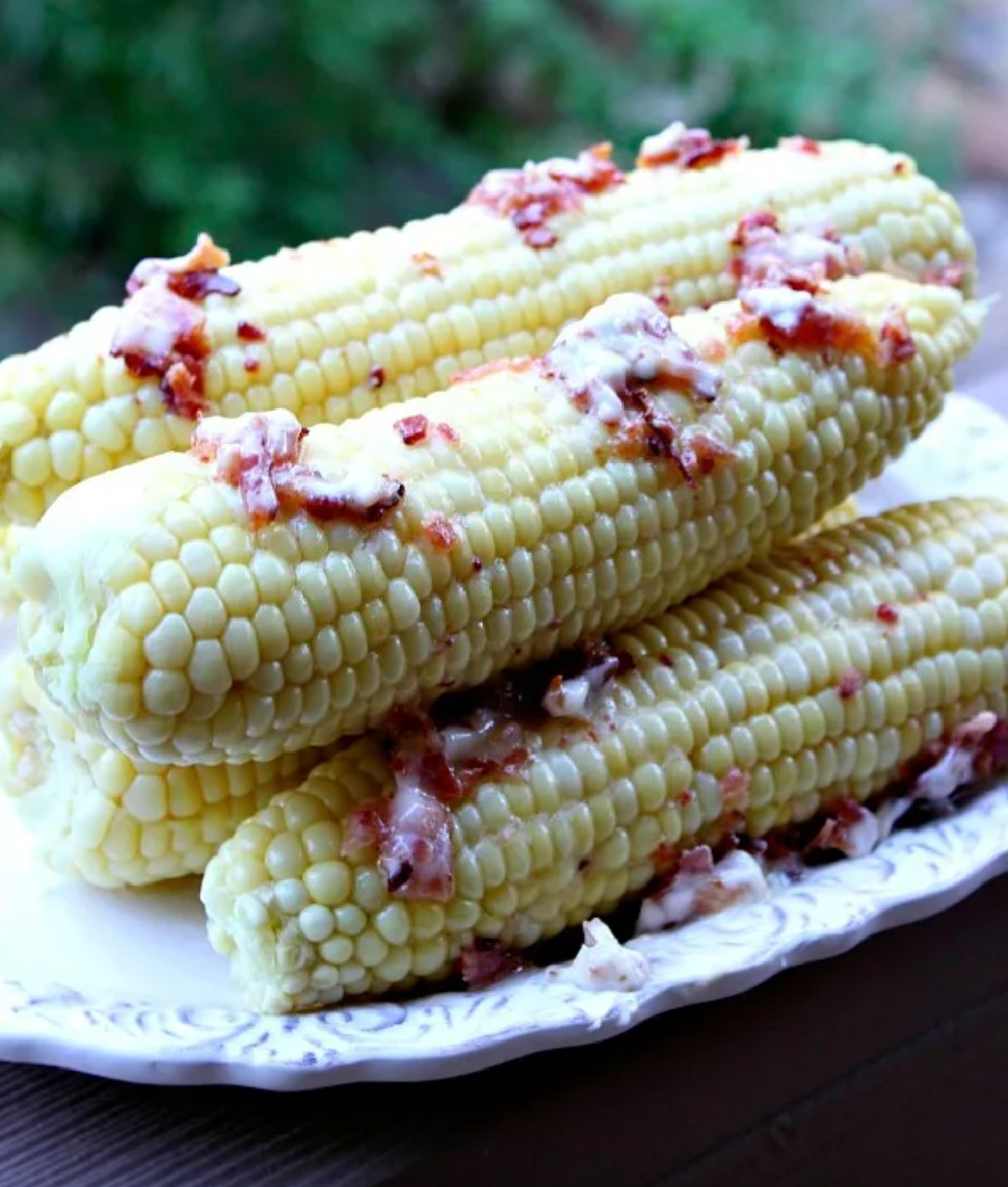 platter of corn on the cob with bacon butter